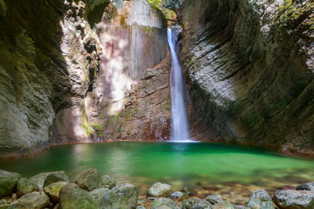 Kozjak waterfalls to the beautiful cave of Triglav National Park Kozjak waterfalls to the beautiful cave of Triglav National Park in Slovenia soca valley stock pictures, royalty-free photos & images