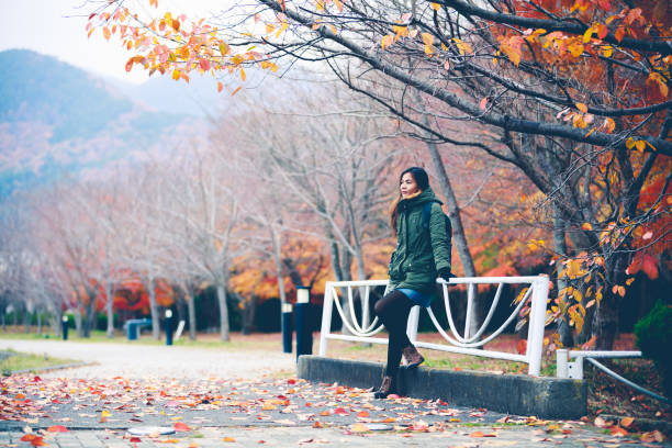 istock Female traveler with backpack in autumn park 849243070