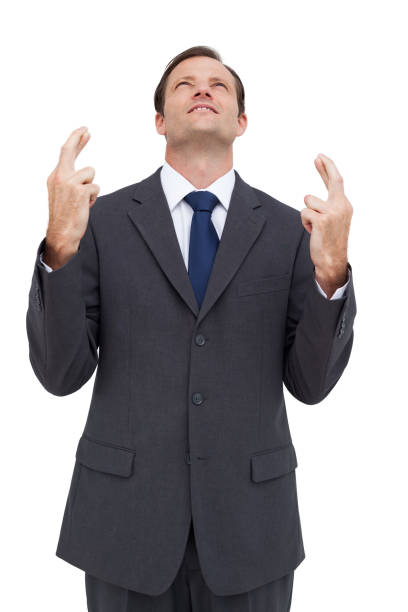 istock Businessman with fingers crossed is looking up 849243750