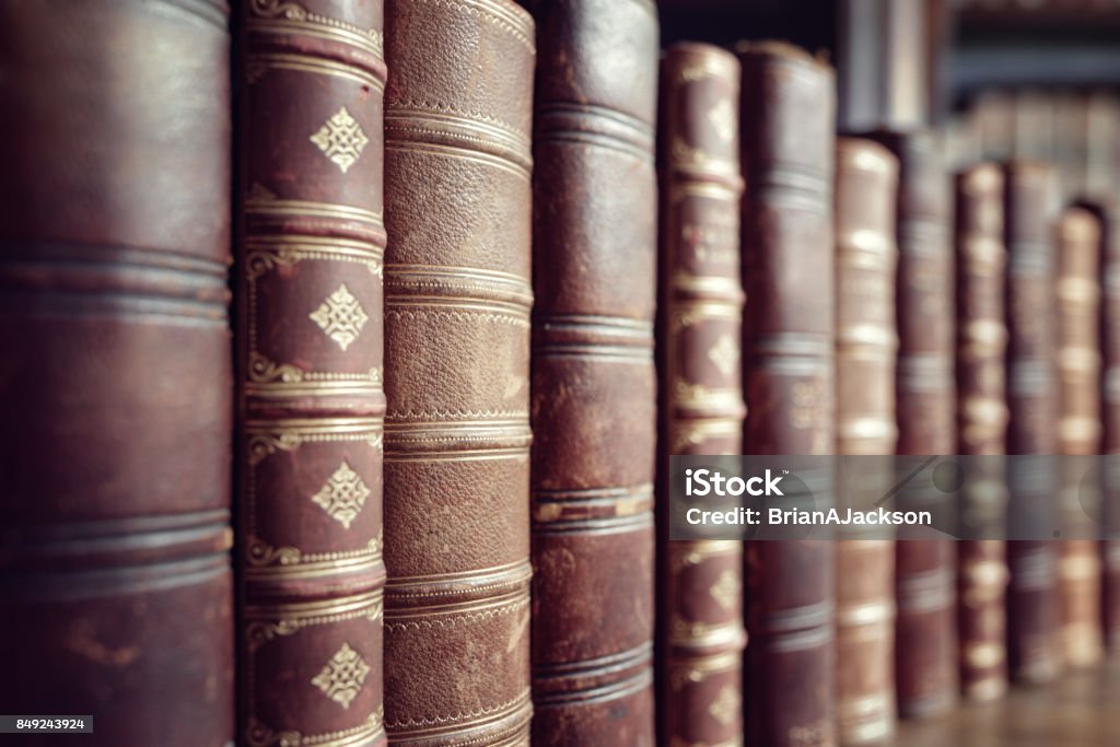 Old vintage books in a row Old leather bound vintage books in a row Book Stock Photo
