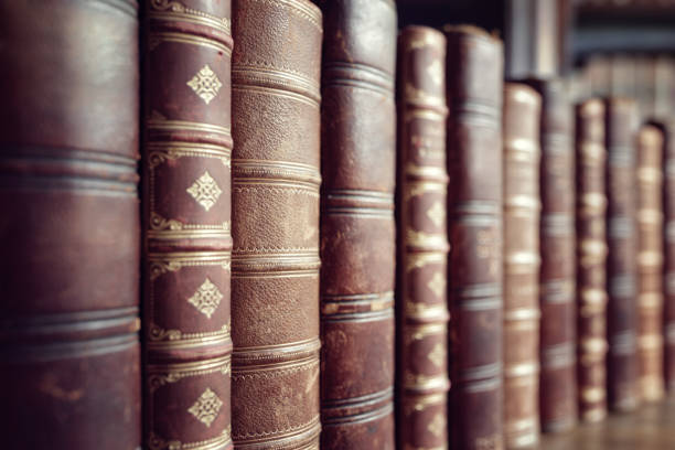 Old vintage books in a row Old leather bound vintage books in a row book display stock pictures, royalty-free photos & images