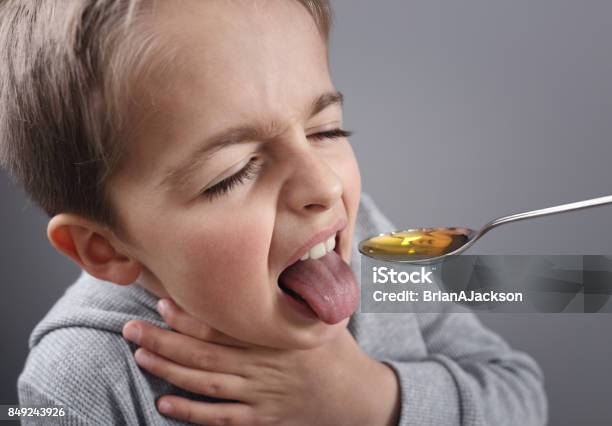 Sick Boy Taking Medicine Stock Photo - Download Image Now - Child, Spoon, Cod Liver Oil