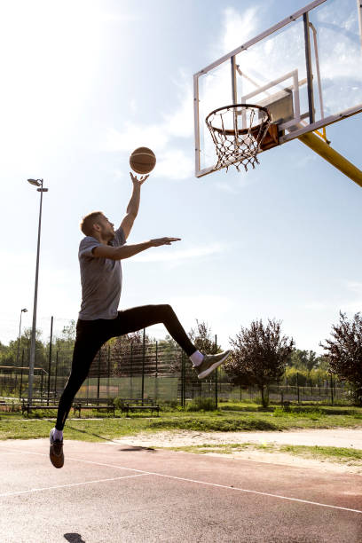 istock Young man jumping on basketball court 849249852