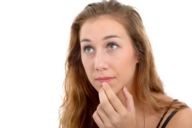 a young beautiful woman thinking looking to the side, on white