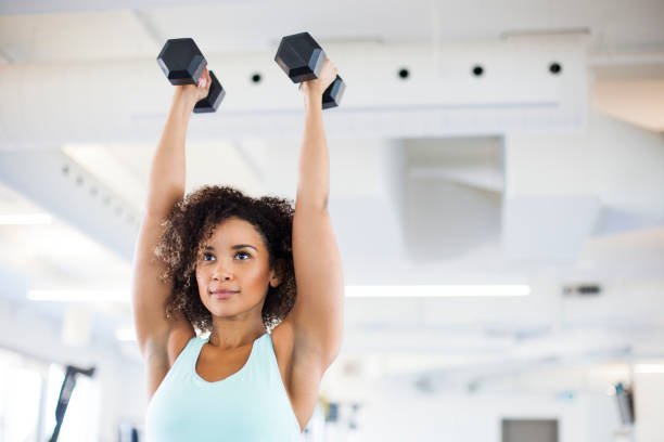istock Young Woman Weightraining at the Gym 849254320