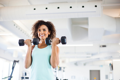 Young Woman Weightraining at the Gym