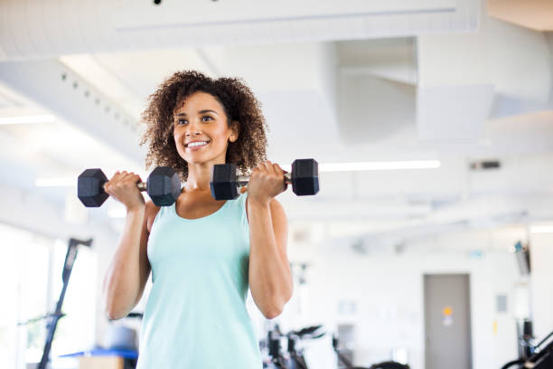 istock Young Woman Weightraining at the Gym 849254342