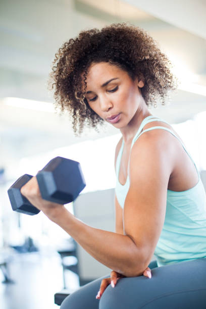 istock Young Woman Weightraining at the Gym 849254370