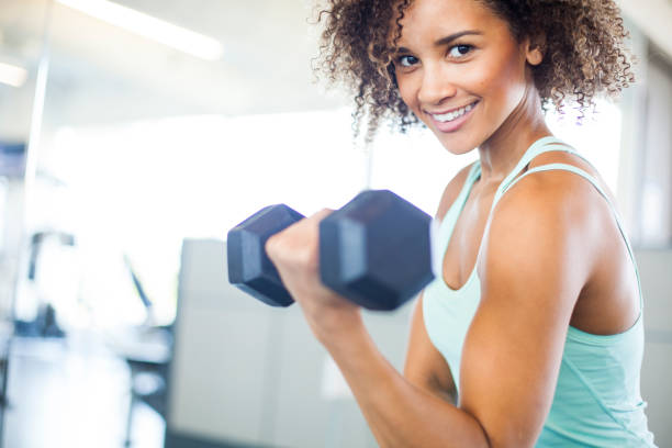 istock Young Woman Weightraining at the Gym 849254402