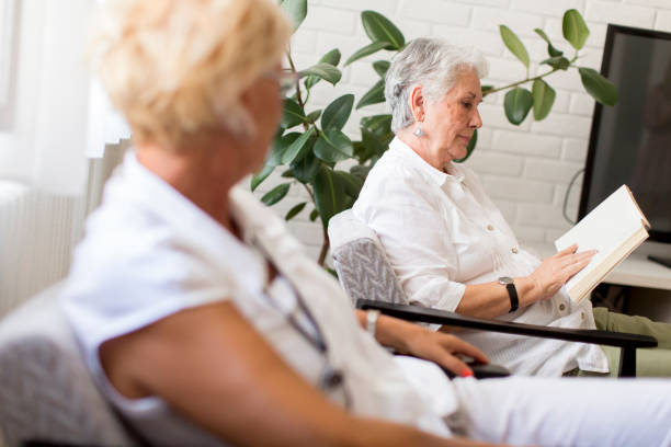 istock Senior charming lady reading a book at home 849255186