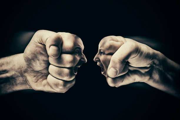 istock Clash of two fists on black background 849255206