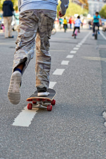 Young teenager boy practice skateboarding