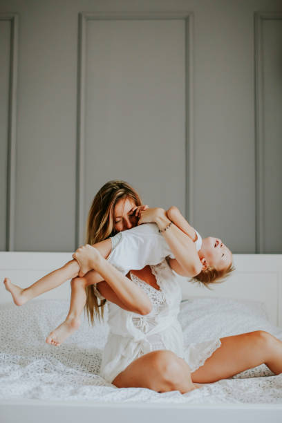 istock Mother playing with little boy on bed 849258770