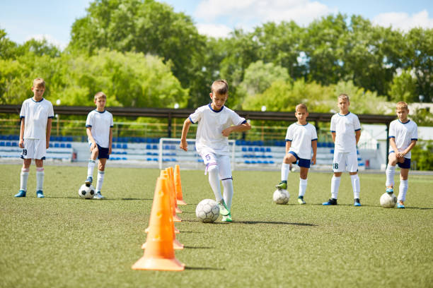 istock Team of Boys Training for Football Game 849258900