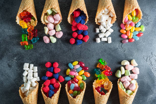 istock Assorted candy in waffle cones. Summer food concept. Flat lay, top view 849264796