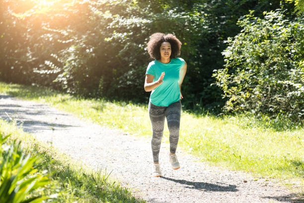 istock African woman jogging in park 849267438