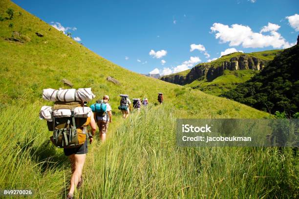 People Hiking Mountains Rucksack Boots Camping Drakensberg Grass Hills Sky Stock Photo - Download Image Now