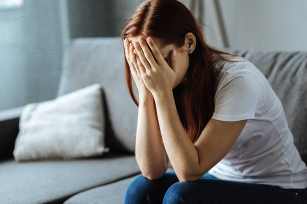 istock Unhappy young woman covering her face 849273130