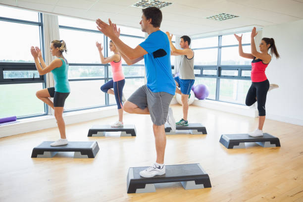 istock Instructor with fitness class performing step aerobics exercise 849273838