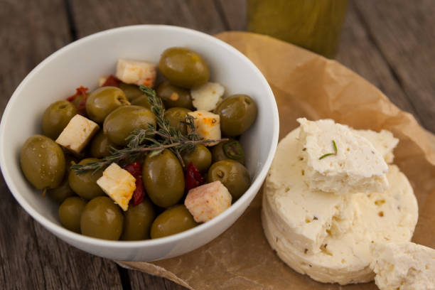 istock High angle view of olives with cheese on wax paper 849274068