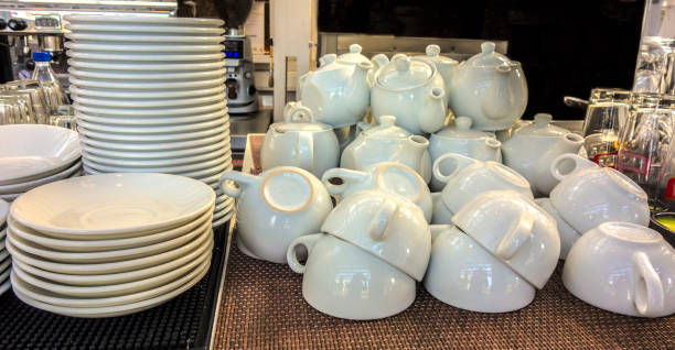 istock Piles of white washed dishes, cups and teapots 849274590