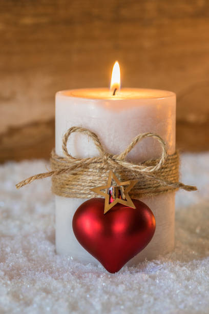 istock Romantic burning candle with red heart shape and star ornament 849283340