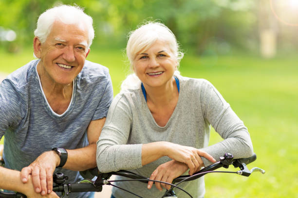istock Senior Couple Riding Bikes In Park 849286642