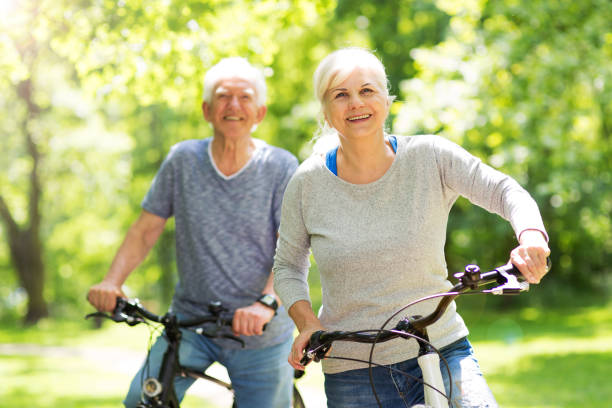 istock Senior Couple Riding Bikes In Park 849286972