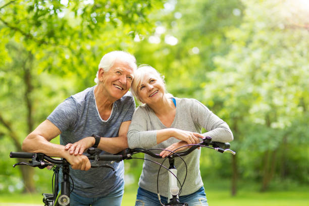 istock Senior Couple Riding Bikes In Park 849287156