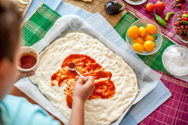 istock High Angle View Of Boy Hands Decorating Pizza Dough Step By Step 849287742