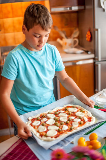 istock Boy Homemade Pizza Is Prepared For Baking 849287792