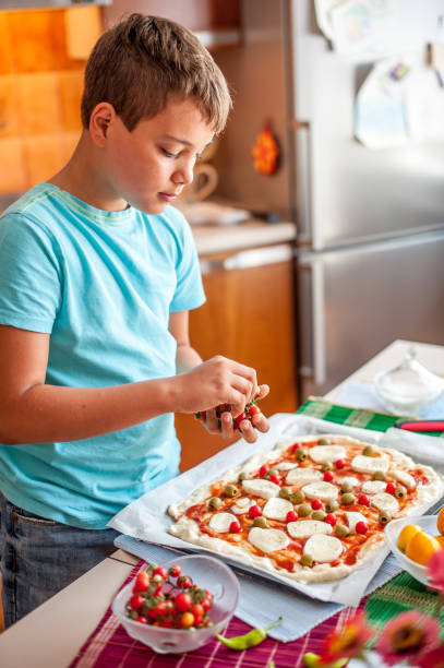 istock Boy Homemade Pizza Is Prepared For Baking 849287818