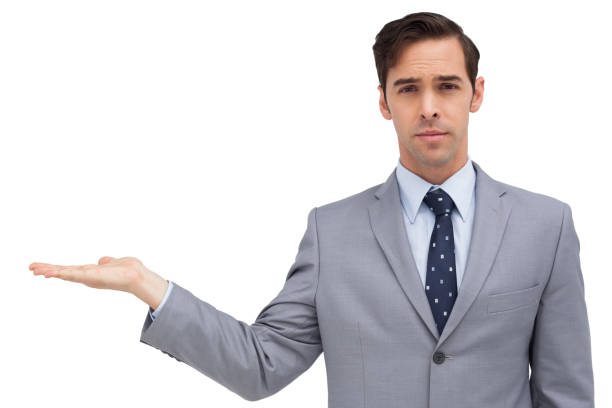 istock Serious businessman with open hand looking at the camera 849292932