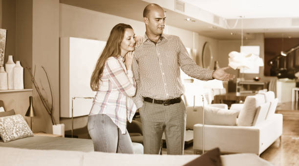 istock Married couple looking for new stylish sofa 849293940