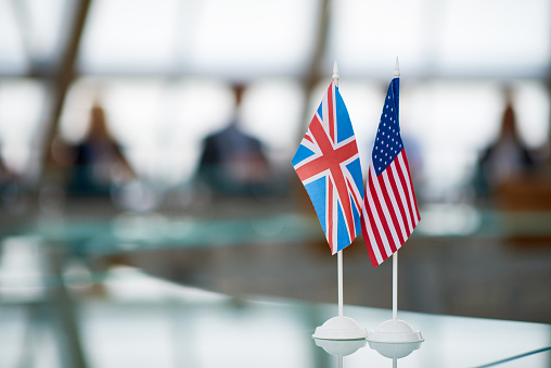 American and Britain flags as symbol of membership placed on glassy table