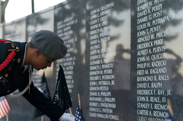 Philadelphia, PA, USA - September 15, 2017: Black POW/MIA flags are planted near the names of 10 veterans still missing in action during an observance of National POW/MIA Recognition Day, at Philadelphia Vietnam Veterans Memorial, in Philadelphia, Pennsylvania.