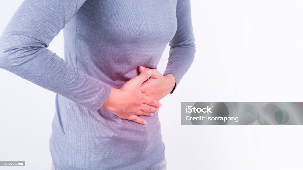 asian woman having stomachache on white background Abdomen Stock Photo