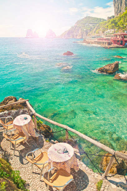 istock two tables at beach cafe with sea and mountain view at sunset 849305634