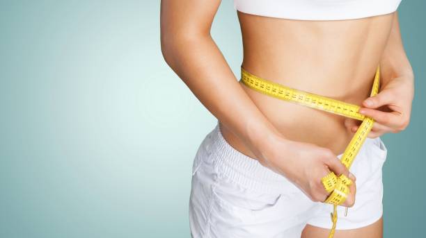 dieting. - measuring waist imagens e fotografias de stock