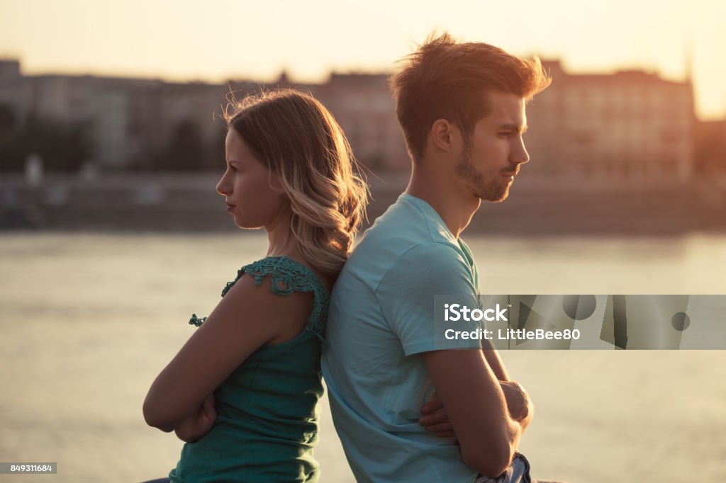 Couple having conflict Young couple having conflict.Image is intentionally toned. Unrequited Love Stock Photo