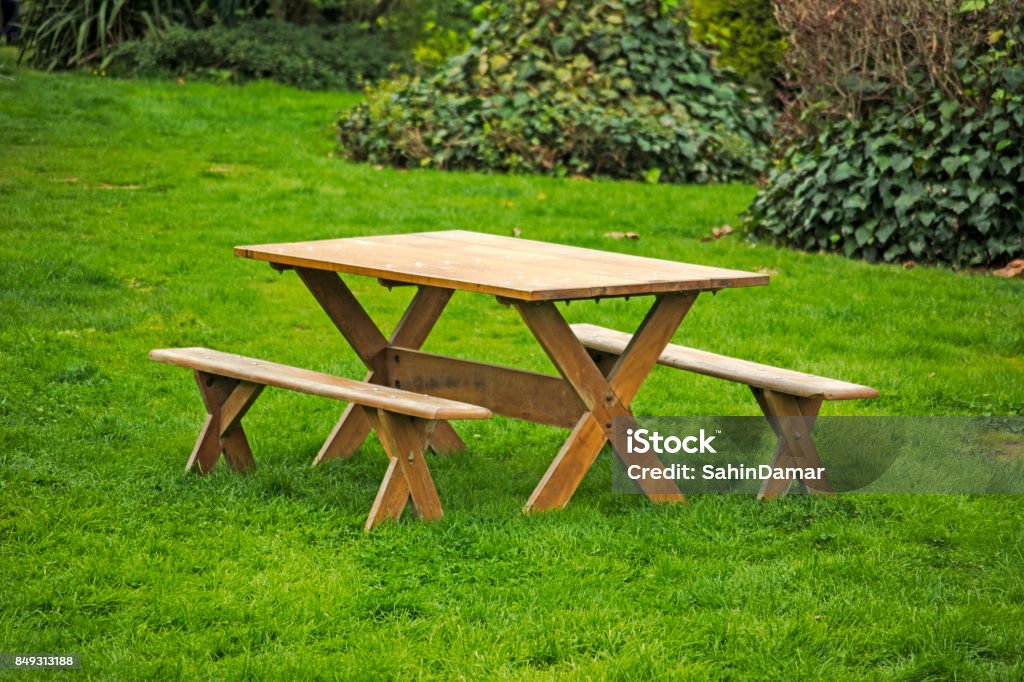 Picnic table on a green meadow Empty picnic table in green meadow and nature holiday area Picnic Table Stock Photo