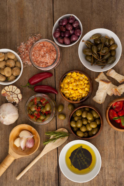 istock Olives with spice and corns with oil in bowl on table 849331002