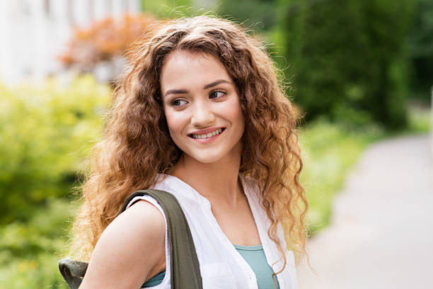 istock Beautiful teenage student posing outdoors in park. 849332168