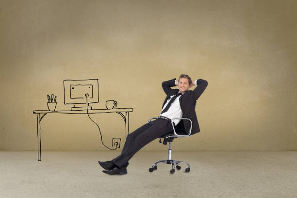 istock Businessman sitting cross armed next to painted desk 849340838
