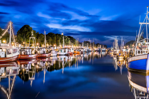 night view of canal with ships and baltic sea in warnemunde, rostock germany - binz imagens e fotografias de stock