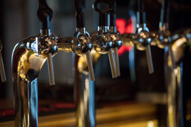 istock Steel beer taps with unusual handles in bar 849345480