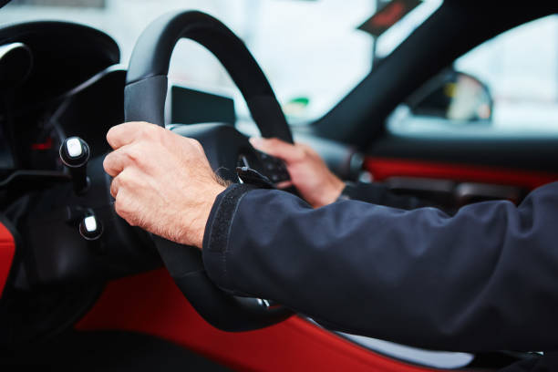 istock Male driver hands holding steering wheel. 849348248