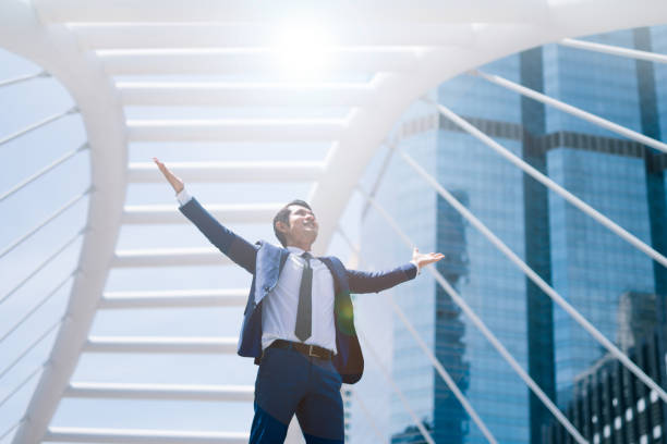 Businessman smiling with arms outstretched success