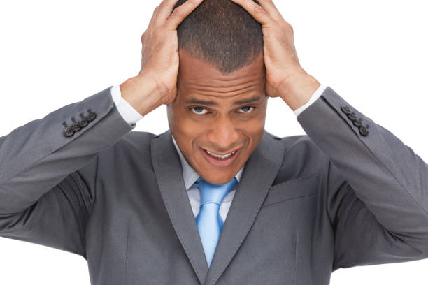 istock Exhausted businessman holding his head between hands 849350878