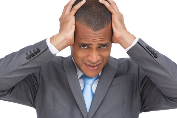 istock Exhausted young businessman holding his head between hands 849352318